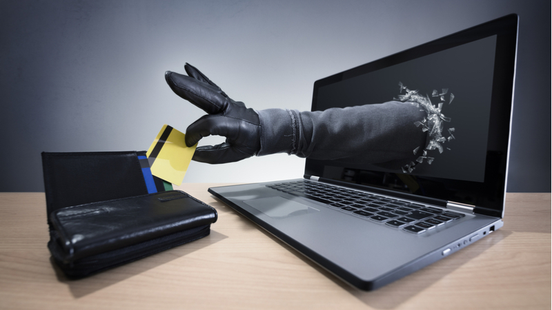 hand out of screen with credit card - idtheft